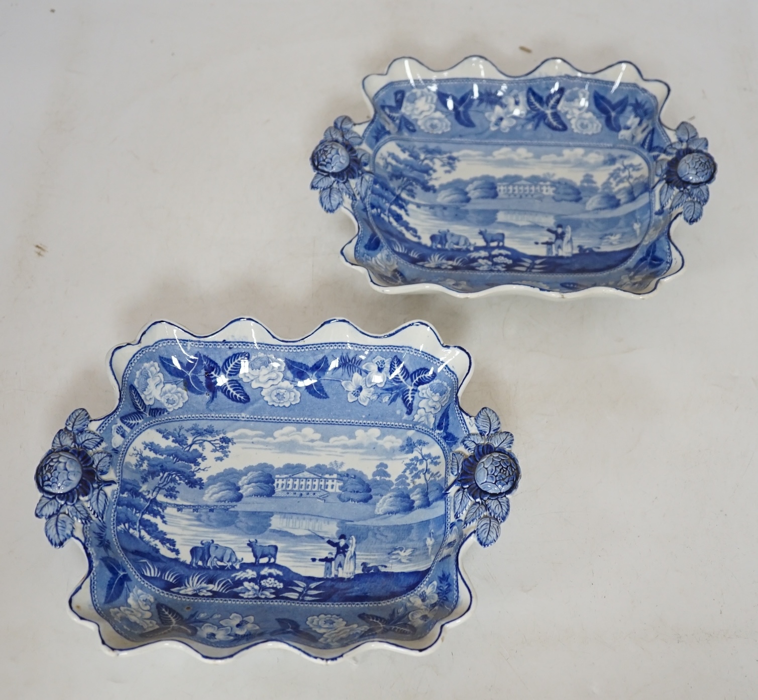 A pair of 19th century ‘British Scenery’, dessert dishes, with floral decorated handles, 24cm wide. Condition - good